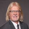 Professional headshot of Larry Gray, CPA, NATP’s IRS liaison for over 20 years, known for expertise in business planning, estate and trust work, and testimony before the Ways and Means Committee.